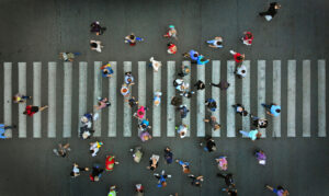 Pedestrian crowd crossing crosswalk, top view.