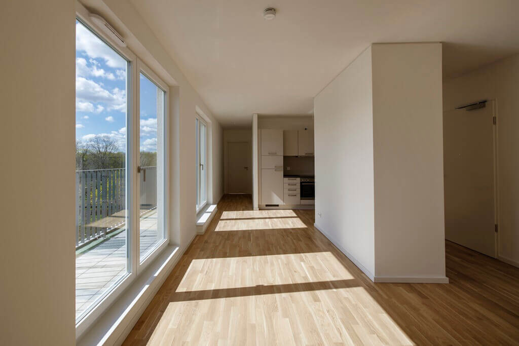 View of the kitchen and balcony in Lacus Quartier apartment